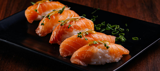 A delicate plate of smoked salmon sushi garnished with microgreens